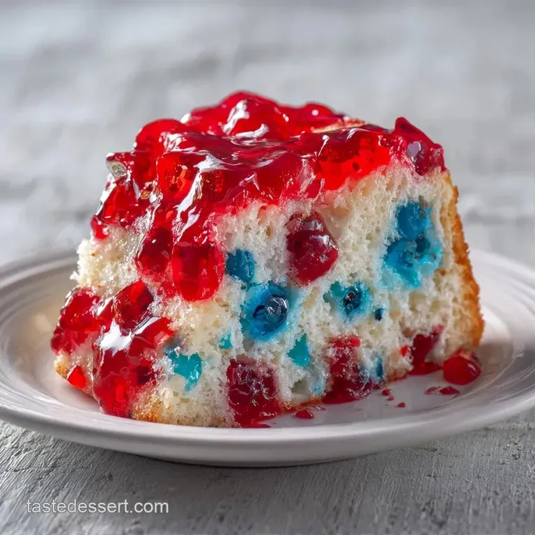 A moist slice of red, white, and blue cake on a clean white plate, adorned with glossy berries and a mint sprig.